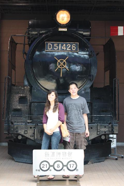 蒸気機関車の前に立つ人々