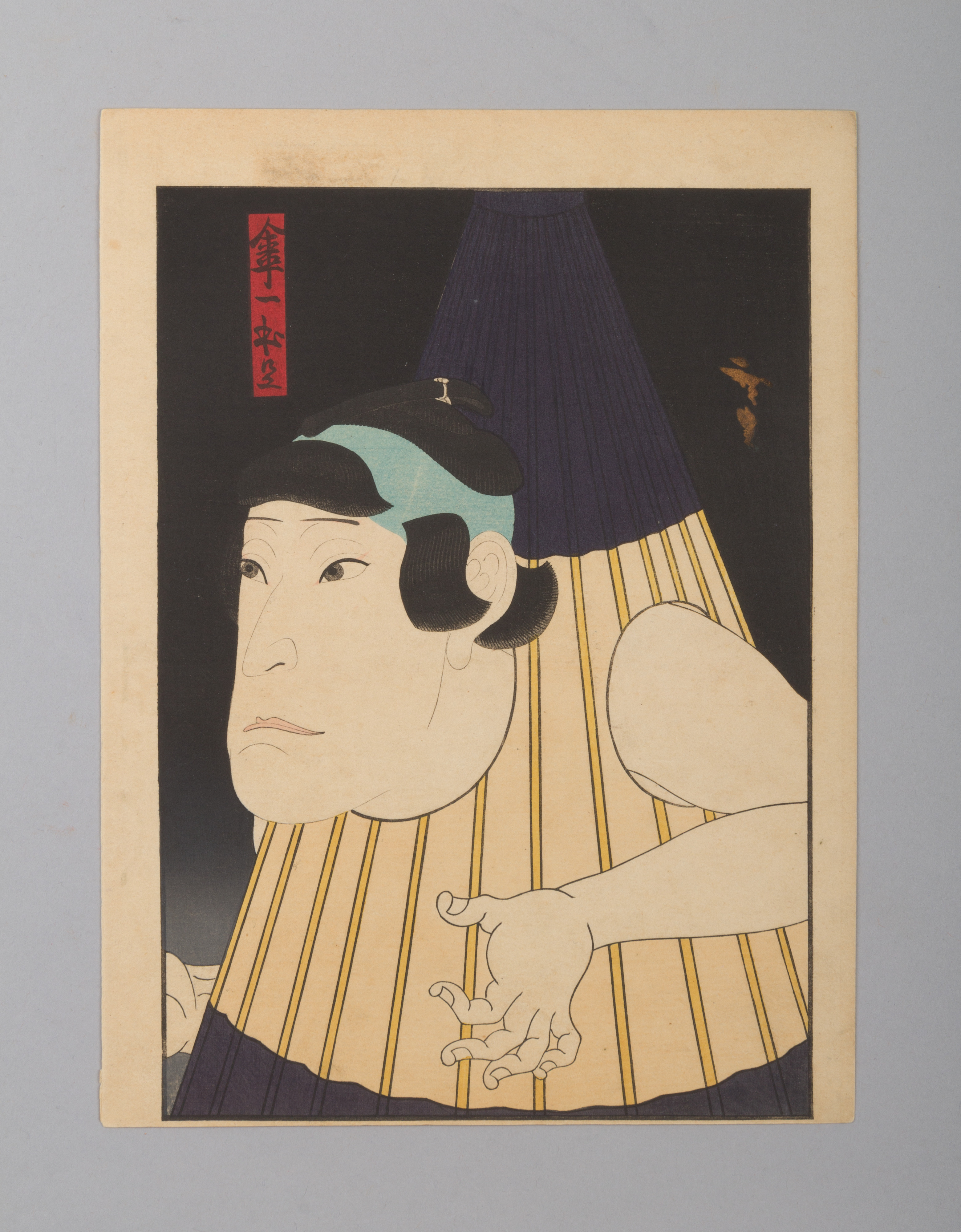 Gosōtei Hirosada’s close-up print of a Kabuki actor wearing a purple and yellow-striped one-legged umbrella costume against black